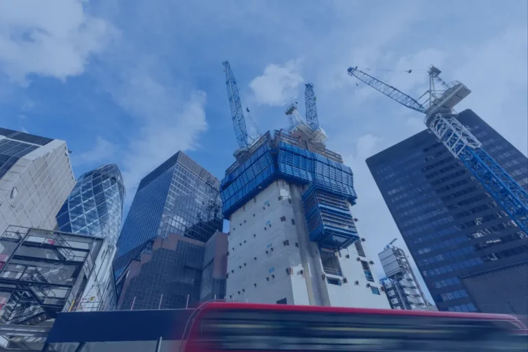 Mezzanine financing in real estate: a skyscraper under construction with tower cranes among the City of London skyline, including 30 St Mary Axe