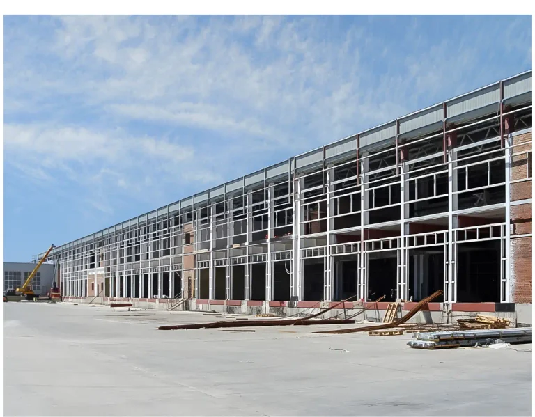 Data center under construction beside an electrical substation and pylons, illustrating data center development financing before a lease is signed